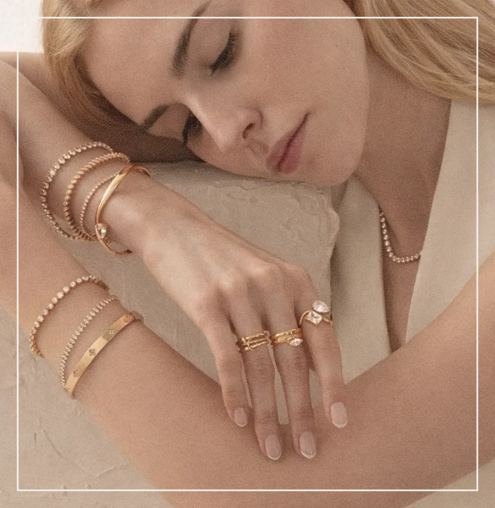 A woman showing her jewelry of rings, bracelets and necklaces
