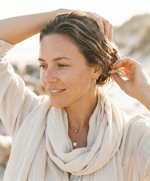 A woman grabbing her hair with jewelry